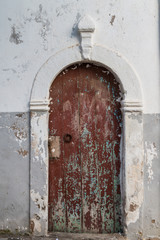 Old wooden weathered door with an arc