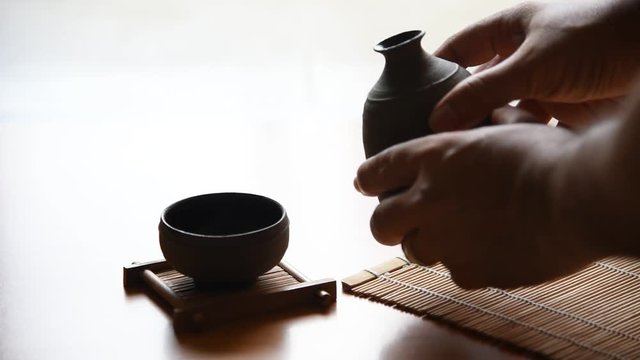 Asian men Pouring japanese sake oriental drink style