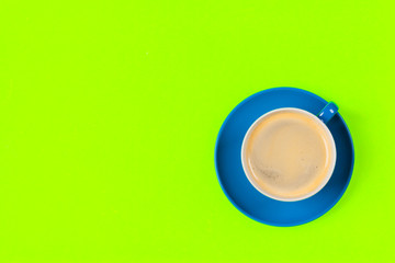 cup of coffee and saucer on color background