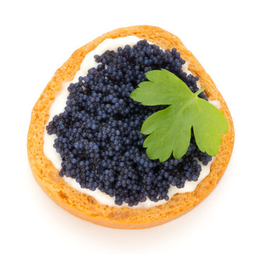 Canapes with black sturgeon caviar and  parsley. Isolated on the white background.