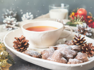 Christmas or new year card. Winter holiday composition, side view, selective focus, blue, gray background. Tea, cookies