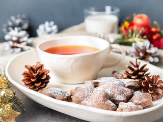 Christmas or new year card. Winter holiday composition, side view, selective focus, blue, gray background. Tea, cookies