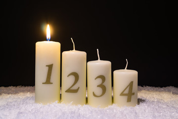 Four Christmas candles in the snow