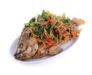 Fried fish with herbs on white