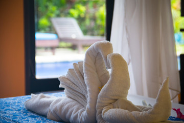 Fancy hotel room with towels folded like swans in Pemuteran in Bali, Indonesia
