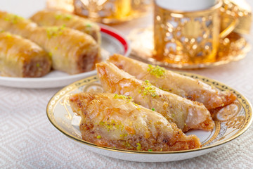 Turkish traditional Dessert Baklava with tea on dark background. Fresh and healthy dessert.