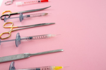 Flat lay of medical instruments on rose background. Mock up health care medical background.