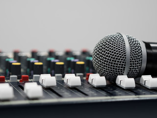 Microphone on audio mixer board in studio