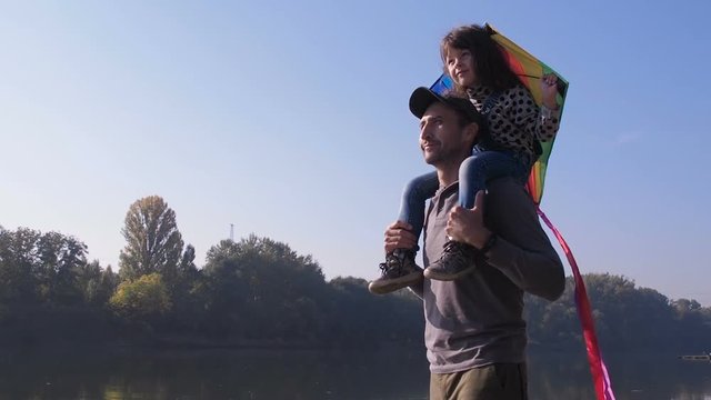 A man with a child in nature. Father with daughter with a kite.