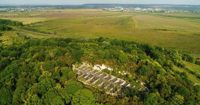 Aerial view of beautiful ancient fortress in forest in summer. Tarakaniv Fort.