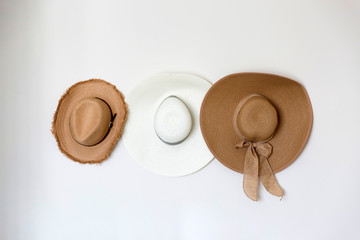 Woman fashion hats hang on wall
