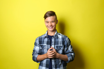 Smiling teenage boy on color background