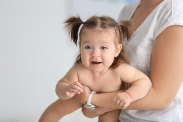 Young mother with cute little baby at home