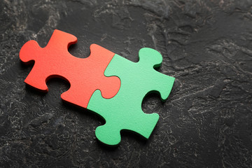 Obraz premium Colorful pieces of puzzle on grey textured background