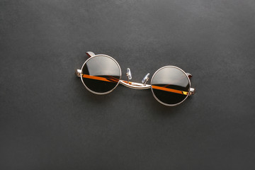 Stylish sunglasses on black background