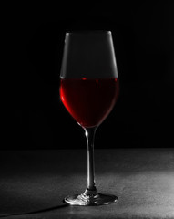 Glass with sweet tasty wine on black background
