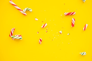broken candy cane on yellow paper background