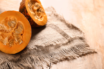 Cut fresh raw pumpkin on wooden table