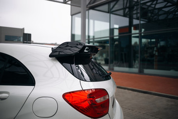Carbon spoiler on the trunk of modern hatchback car - obrazy, fototapety, plakaty