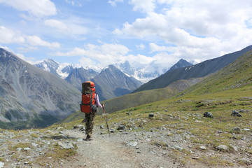 Fototapeta premium Tourist woman standing on Pass Kara-Turek against the Belukha Mountain, Altai, Russia