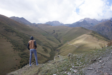 man is walking on the high mountain in Kazbegi, Georgia