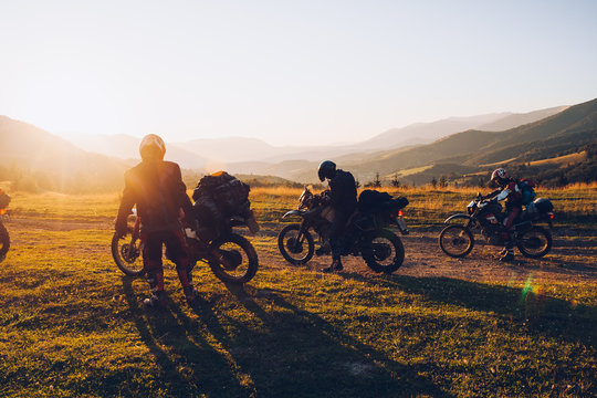 Stunning image of the group of bikers in the evening light. Concept active extreme rest.