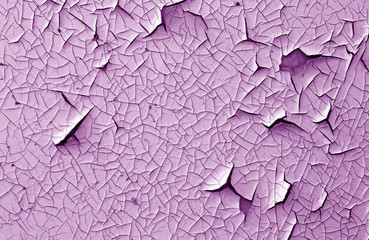 Crack and damage on painted texture in purple tone.