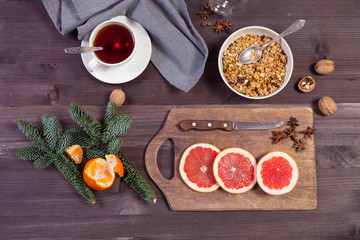 Set for mulled wine: sliced grapefruit with anise on the board on the wooden brown background.