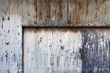 a stained corrogated door in old town