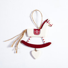 the wooden toy to decorate the Christmas tree on a white wooden table