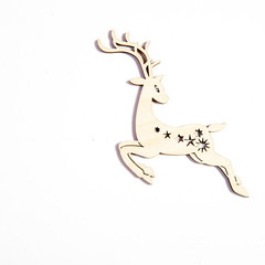 the wooden toy to decorate the Christmas tree on a white wooden table