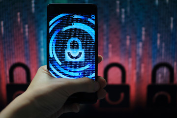 hand holding mobile phone with padlock icon symbolize security displayed on touch screen. privacy and protection from virus. Dark red padlock icon in the backgrounds