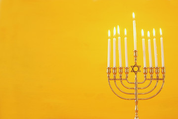 image of jewish holiday Hanukkah background with menorah (traditional candelabra) and candles.