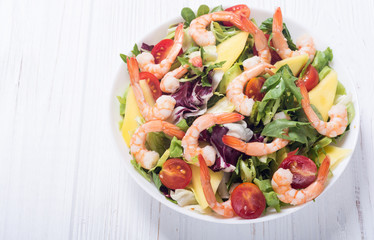 Mix of salad with shrimps , avocado and cherry tomatoes