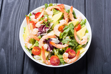 Mix of salad with shrimps , avocado and cherry tomatoes