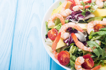 Mix of salad with shrimps , avocado and cherry tomatoes