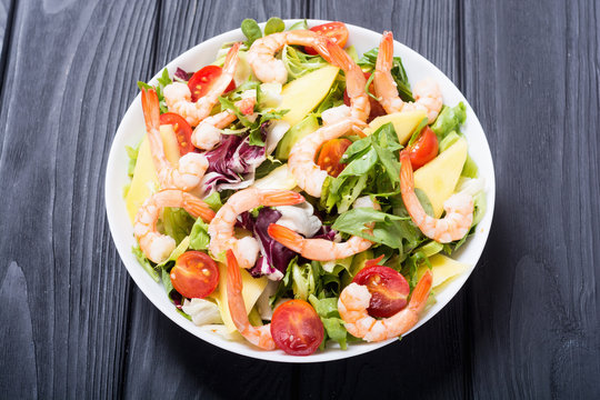 Mix of salad with shrimps , avocado and cherry tomatoes