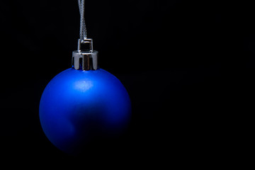 Christmas ball in blue on a black background