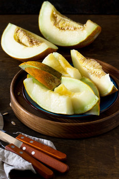 Melon. Fresh sliced melon in  a plate on  the wooden table.  Copy space.