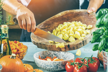 The chef slicing vegetables.