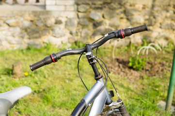 Fototapeta na wymiar Bicycle handlebar on the lawn during active walks