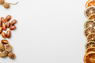 autumn composition with pine cones, slices of dried oranges and acorns, autumn concept, flat lay, top view