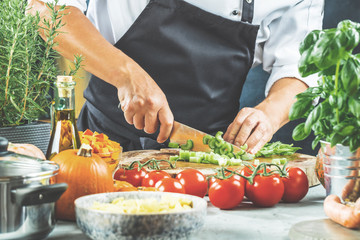 The chef slicing vegetables.