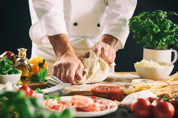 Chef kneading pastry dough for pasta or pizza