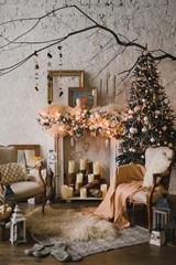 Christmas at home, cozy armchairs near the fireplace. Pine tree with colorful balls, toys and garlands. Winter ornaments. New Year decorations and gifts. Coziness, celebration, winter, feast, holidays