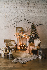 Christmas at home, cozy armchairs near the fireplace. Pine tree with colorful balls, toys and garlands. Winter ornaments. New Year decorations and gifts. Coziness, celebration, winter, feast, holidays