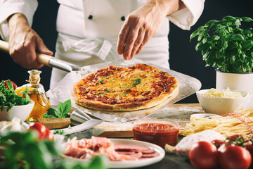 Chef preparing Italian pizza using a paddle