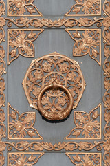 Fototapeta na wymiar Door knocker on ancient wooden door in Kiev, Ukraine