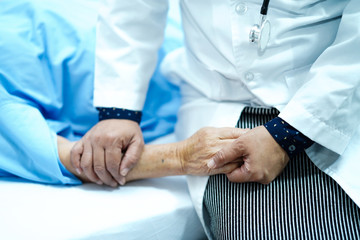 Touching hands Asian senior or elderly old lady woman patient with love, care, helping, encourage and empathy at nursing hospital ward : healthy strong medical concept 