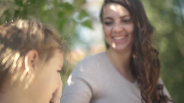 Mom strokes daughter's face and pokes her nose